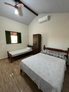 a bedroom with a bed and a ceiling fan at Chalés Relíquias da Canastra Il in São Roque de Minas