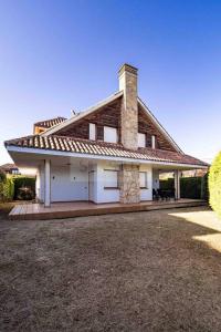 a large white house with a tile roof at Casa Costera Gijón By Silastur in Gijón