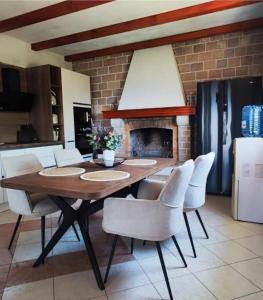a dining room with a table and chairs and a fireplace at House Ita in Postira