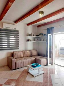 a living room with a couch and a table at House Ita in Postira