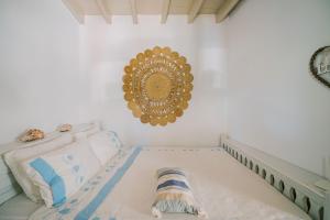 a bedroom with a bed and a mirror on the wall at Lampi's House in Patmos