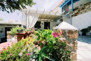 a garden in front of a house with flowers at Lampi's House in Patmos