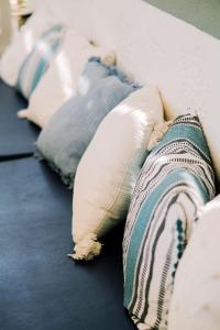 a group of pillows sitting on a bed at Lampi's House in Patmos
