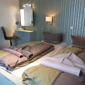 a room with two beds with towels on them at Ferienwohnungen "Strand & Gut" - Dietmar Opel in Zempin