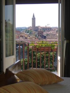 a bedroom with a bed and a window with a view at Agli Abbaini in Verona