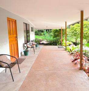 an empty patio with chairs and plants at Rayo de Luna in Monteverde Costa Rica