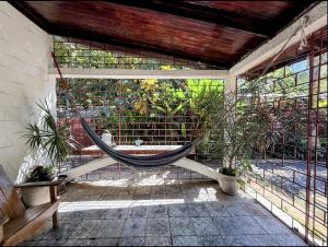 a hammock in a room with plants at Hostal Tia Reyna in El Zonte