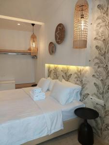 a bedroom with a bed with towels on it at Hotel Alexandra in Skala
