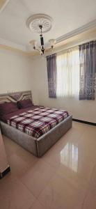 a bedroom with a bed and a ceiling at Rahma furnished apartment 2 in Addis Ababa