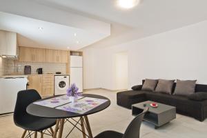 a living room with a couch and a table at The Central Stay in Karpathos