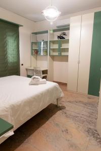 a bedroom with a white bed and green cabinets at Vesuvio Fantasy View in San Giuseppe Vesuviano