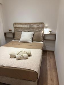 a bedroom with a large bed with a headboard at Le Christina in Saint-Paul