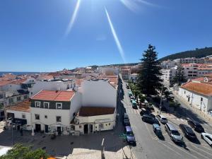 an aerial view of a city with cars parked in a parking lot at Sesimbra Universal in Sesimbra