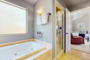 a large bathroom with a tub and a window at Sweet Vista in Groveland +18 photos