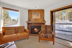 a living room with a couch and a fireplace at Double Eagle A12 by Ski Country Resorts in Breckenridge