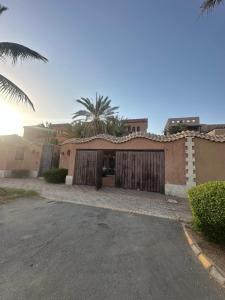 a house with a garage and a palm tree at villa sea view in Jeddah
