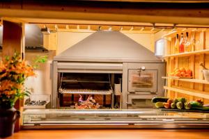 a kitchen with an oven with a pizza in it at Hotel Noguera El Albir in Albir