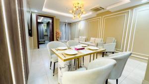 a dining room with a table and chairs at Luxurious One-Bedroom Gold Crest Apartment with Stunning Balcony Retreat DHA Lahore in Dargai