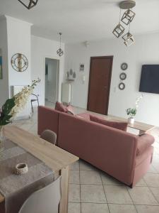 a living room with a couch and a table at casa vacanza in Nea Moudania