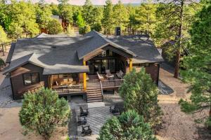 an aerial view of a log home with a porch at Fireplace and EV Charger! Home in Torreon Community in Show Low
