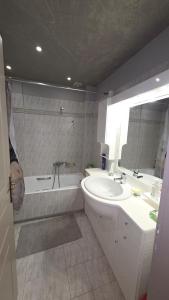 a bathroom with a sink and a bath tub at Dimitris gerakas apartment in Mesochórion