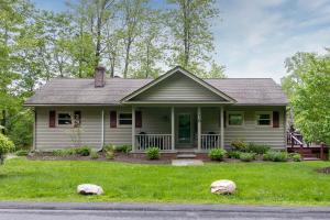 a house with two rocks in the front yard at Berkshire Vacation Rentals: Great Barrington Walkable To Lake And Town in Great Barrington