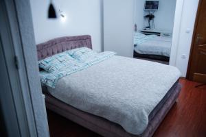 a bedroom with a bed with a white comforter at Apartment NAV in Plav