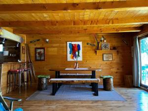 a wooden room with a table and a bench at Guest House Milena in Žabljak