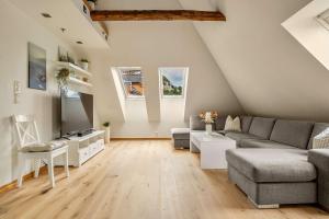 a living room with a couch and a table at DINBNB Apartments l 200m to Bryggen l Luxury 2 BR l 2min to Floibanen in Bergen