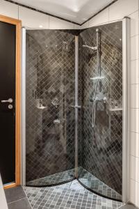 a shower with a glass door in a bathroom at DINBNB Apartments l 200m to Bryggen l Luxury 2 BR l 2min to Floibanen in Bergen +18 photos