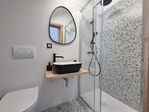 a bathroom with a sink and a mirror at Cozy cottage with seaview and parking ideal for small family in Brzac +14 photos