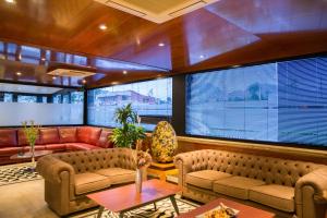 a living room with couches and tables and windows at Hotel Noguera El Albir in Albir