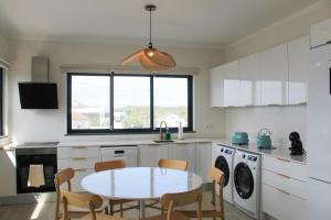 a kitchen with a table and chairs in a kitchen at Serena in Madalena