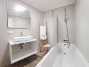 Un baño blanco con lavabo y bañera. en Serena, en Madalena 31 fotos más