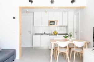 a kitchen and dining room with a table and chairs at BAO 3 Apartamento con terraza in Somo