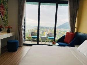 a hotel room with a bed and a large window at The Lucky House in Thanh Hóa