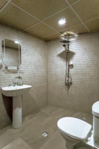 a bathroom with a white toilet and a sink at sermest house in Sanlıurfa