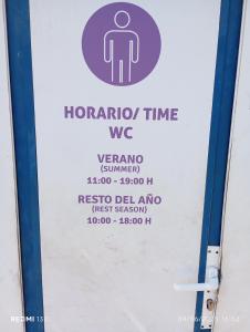 a sign on the door of a bathroom with a sign for a toilet at Camper K Not for driving Playa las Vistas in Adeje