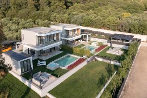 an aerial view of a house with a swimming pool at Estellar Villas, 50meters from the Sea in Neos Marmaras