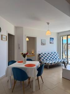 a living room with a table and chairs and a couch at Casa Vacanze Matilde Marzamemi in Marzamemi