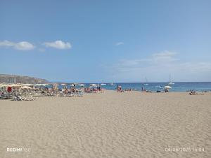 a group of people sitting on the beach at Camper K Not for driving Playa las Vistas in Adeje