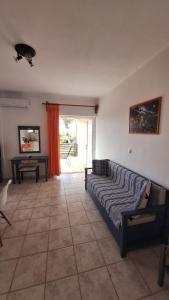 a living room with a couch and a table at Kalliopi Studios - Apartments in Kato Daratso