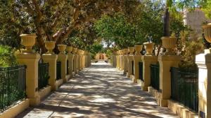a fence with vases on it next to a sidewalk at 4 Borgo Vilhena - Home in Floriana in Il-Furjana