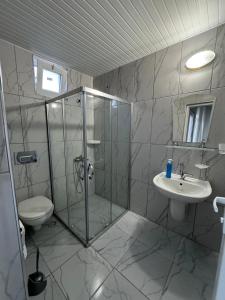 a bathroom with a shower and a toilet and a sink at Atlas Bungalows in Kumluca +46 photos