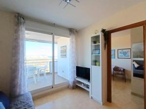 Televízia a/alebo spoločenská miestnosť v ubytovaní AyF VISTAS A LA PLAYA MORRO DE GOS Y WIFI