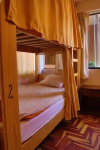two bunk beds in a bedroom with the number two at Shanti Hotel Pisac in Pisac