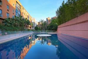 a pool of water in a city with buildings at Spacious 3Br Apartment-Pool&AC- Heart of Marrakech- Hivernage in Marrakech