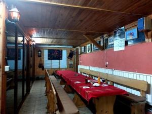 a row of tables in a restaurant with red table cloth at Heaven in Draginovo
