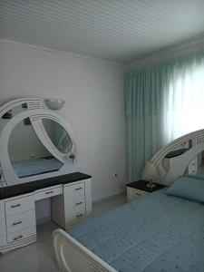 a bedroom with a bed with two mirrors on it at Cozy flat in Nea Makri in Nea Makri