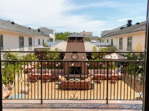 a balcony with a fireplace in a yard at The Ryder Hotel in Charleston